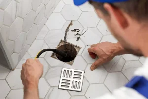 https://www.shutterstock.com/image-photo/plumber-unclogging-blocked-shower-drain-hydro-2554053133